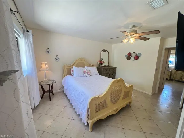 Tiled bedroom with ceiling fan