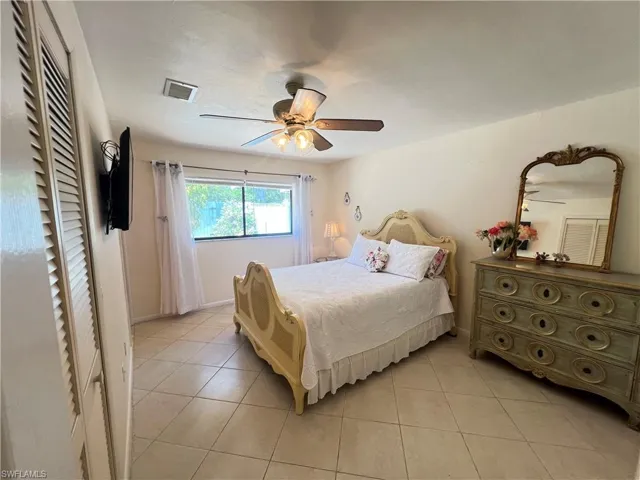 Bedroom featuring ceiling fan and light tile flooring