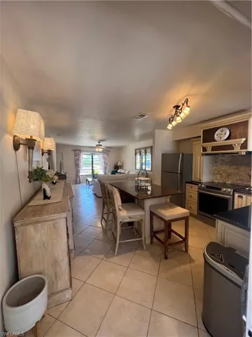 Tiled dining room featuring ceiling fan