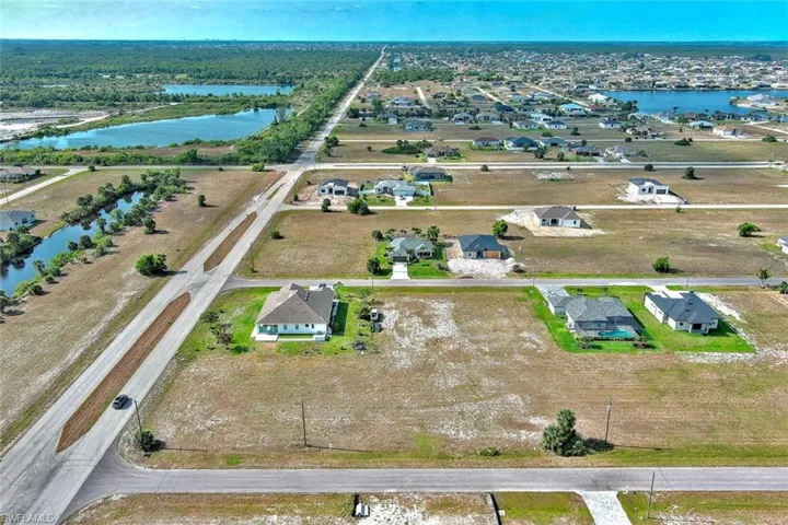 Aerial view of residential area featuring a nearby body of water