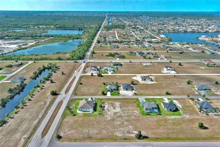 Aerial view of property's location with a nearby body of water