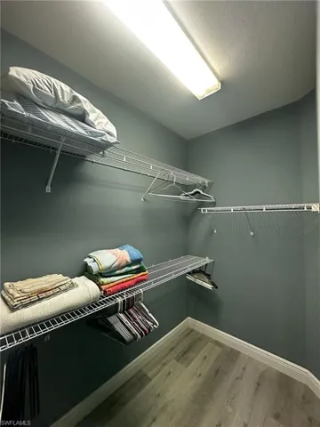 Walk in closet featuring wood finished floors