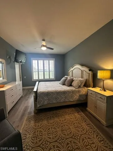 Bedroom featuring dark wood finished floors and a ceiling fan