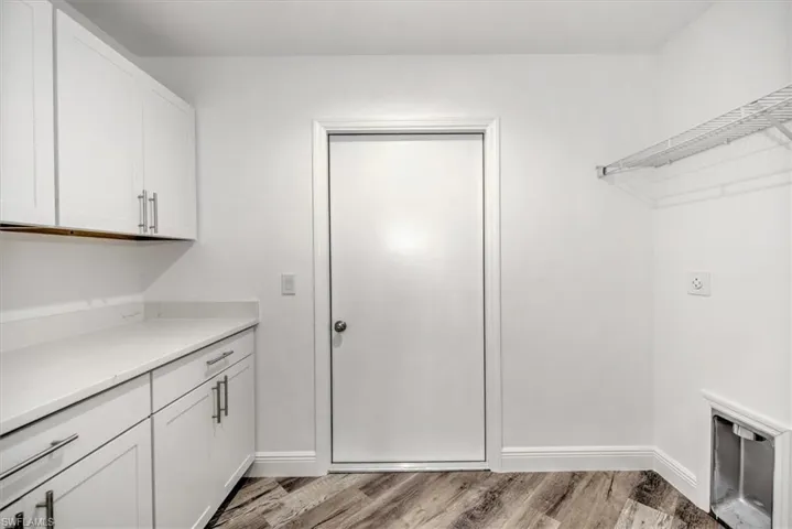 The laundry room has cabinets on the left top and bottom that is often used as the pantry or just extra storage.