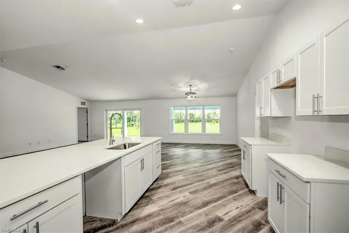 Kitchen view with Quartz countertops and wood cabinets.