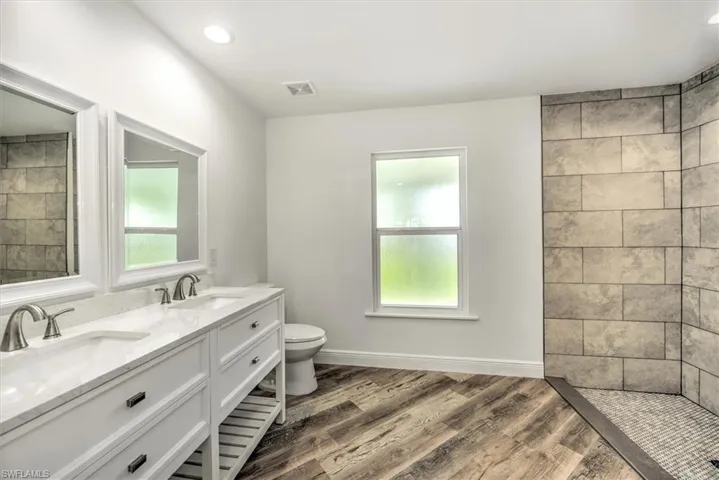 Master bathroom features dual sinks and a nice walk in shower with 12 x 24 tiles