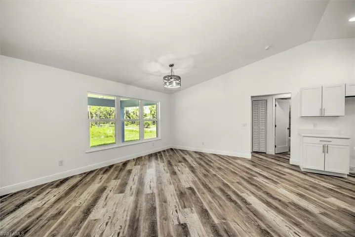 Dining area off the kitchen with triple window view of the backyard.