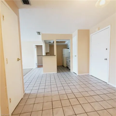 Unfurnished living room featuring light tile patterned floors