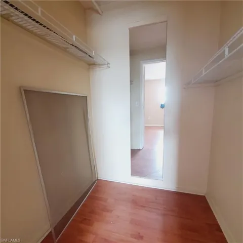 Walk in closet featuring wood finished floors