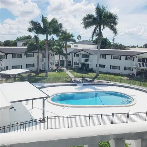 Community pool featuring a patio and a residential view