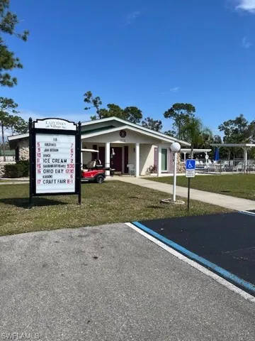 View of parking featuring a yard
