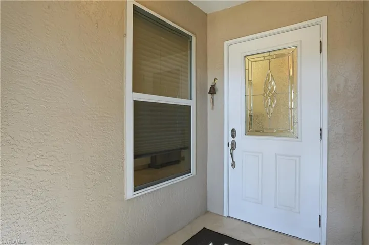 Entrance to property with stucco siding