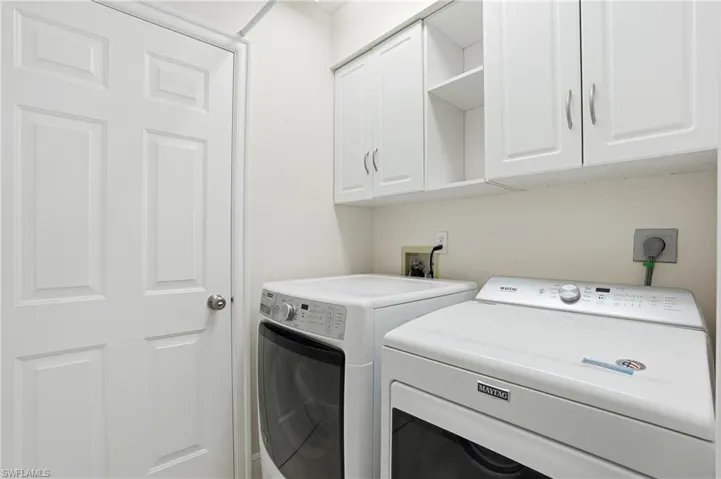 Washroom with cabinet space and separate washer and dryer