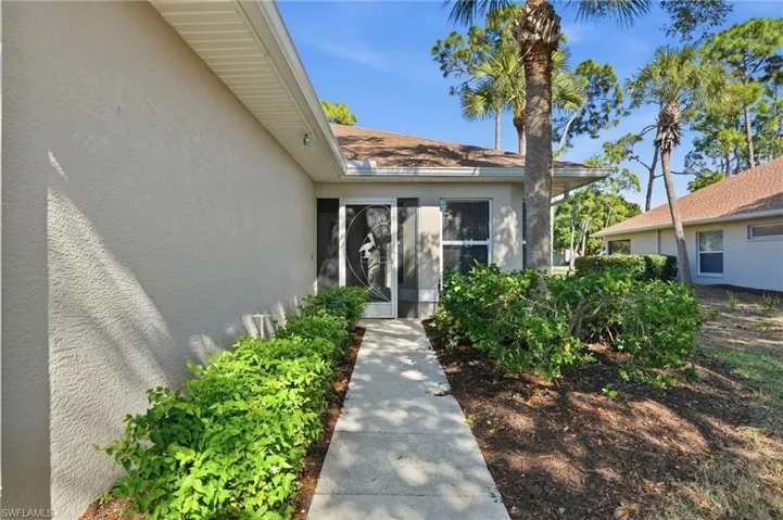 Property entrance featuring stucco siding