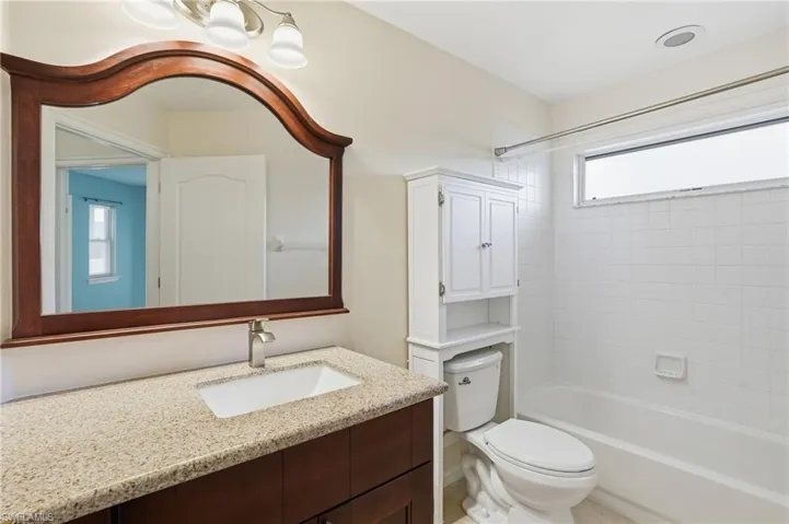 Bathroom featuring vanity and washtub / shower combination
