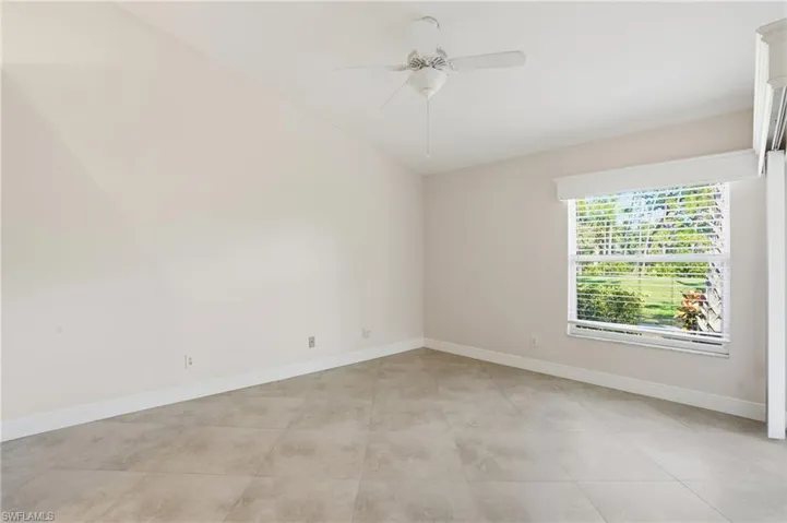 Spare room with ceiling fan and vaulted ceiling