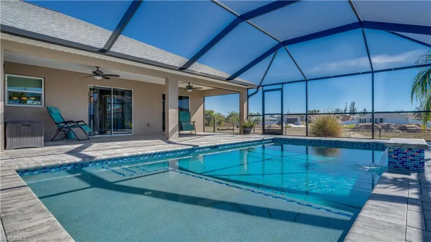 Outdoor pool with a lanai, a patio area