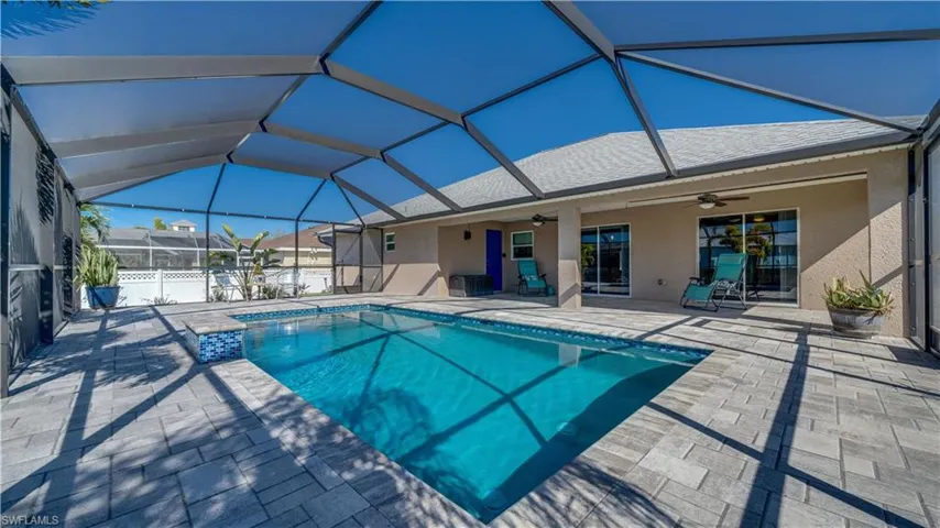 Outdoor pool with a patio area and a screened enclosure