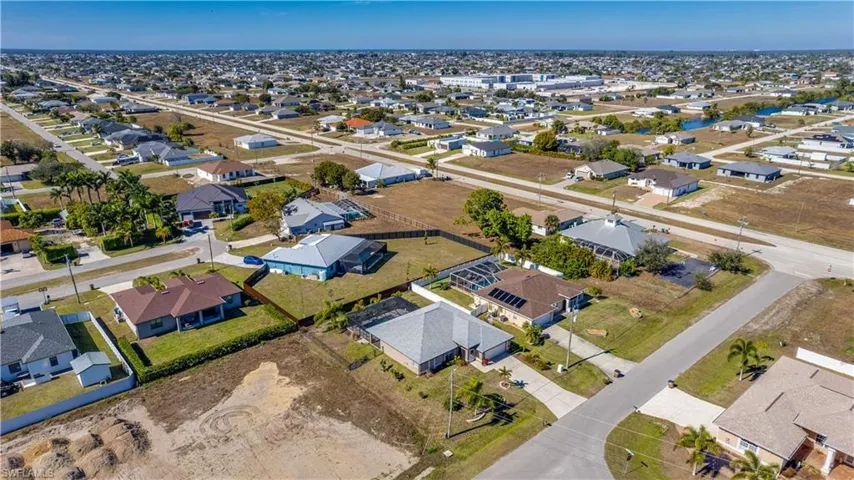 Aerial view of property's location with nearby suburban area