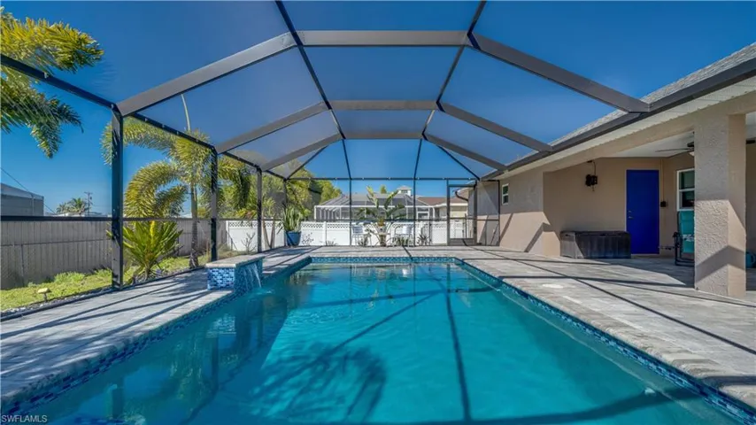 View of pool with a fenced backyard, a patio area, and screened enclosure