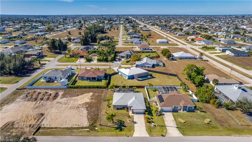 Aerial view of property's location with nearby suburban area