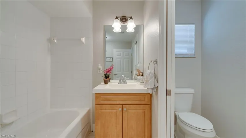 Pool bath - full bathroom featuring vanity and tub / shower combination