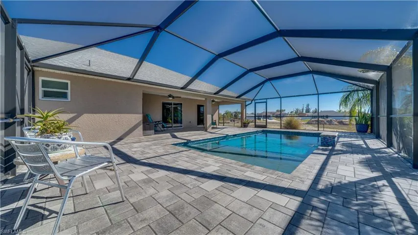 Outdoor pool with a patio, a lanai, and grilling area