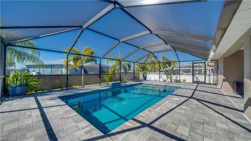 View of pool featuring a lanai, a patio area, and a fenced backyard