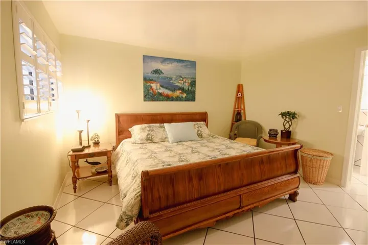 Bedroom with light tile patterned flooring