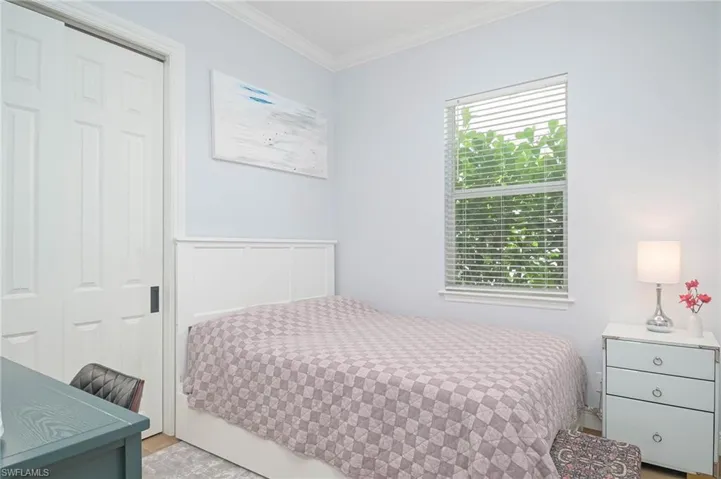 Bedroom 4 featuring a closet, ornamental molding, and plenty of light