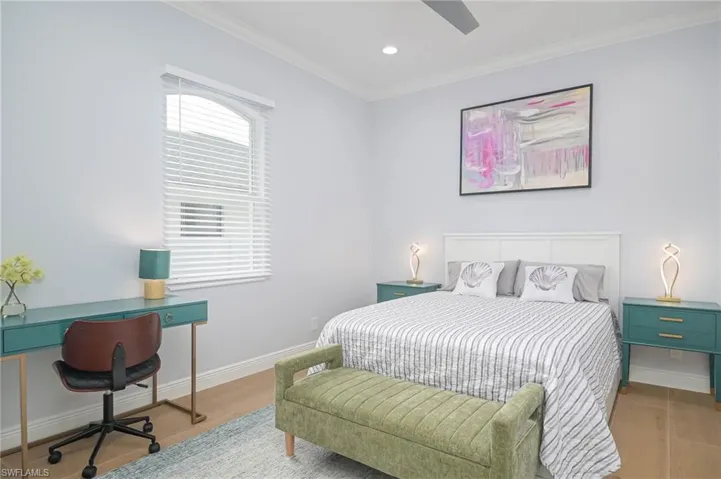 Bedroom 3 featuring light floors, crown molding, and ceiling fan