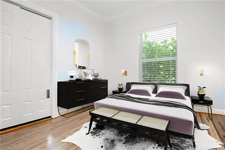 Virtually Staged Bedroom with light hardwood / wood-style floors, a closet, and ornamental molding