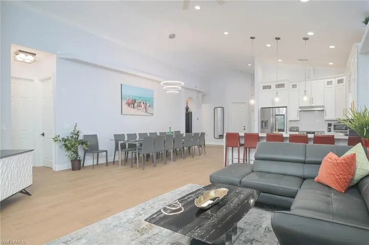 Living room featuring light hardwood / wood-style floors and high vaulted ceiling