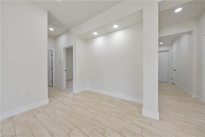 Spare room with light wood-style flooring and recessed lighting