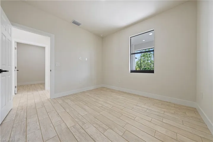 Primary room featuring light wood-style floors and baseboards