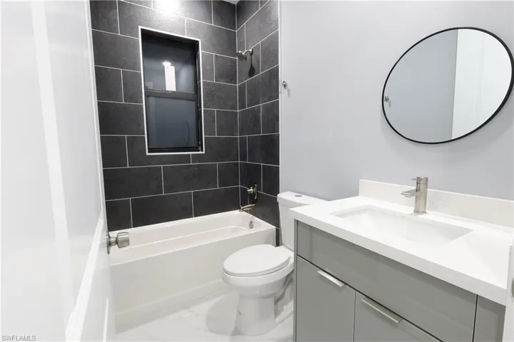 Bathroom with vanity and  shower combination