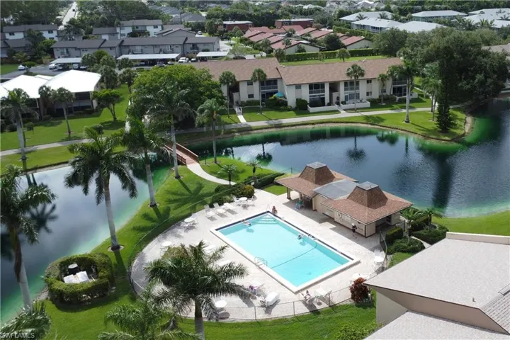 Aerial view of residential area featuring a nearby body of water