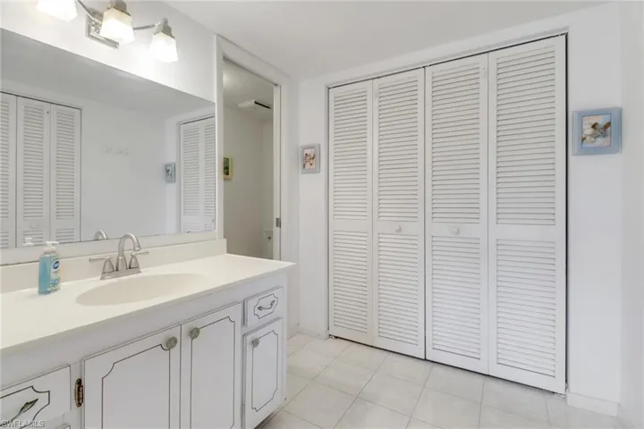 Bathroom with a closet and vanity