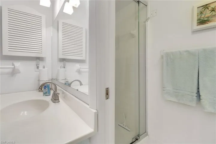 Bathroom featuring a shower stall and vanity