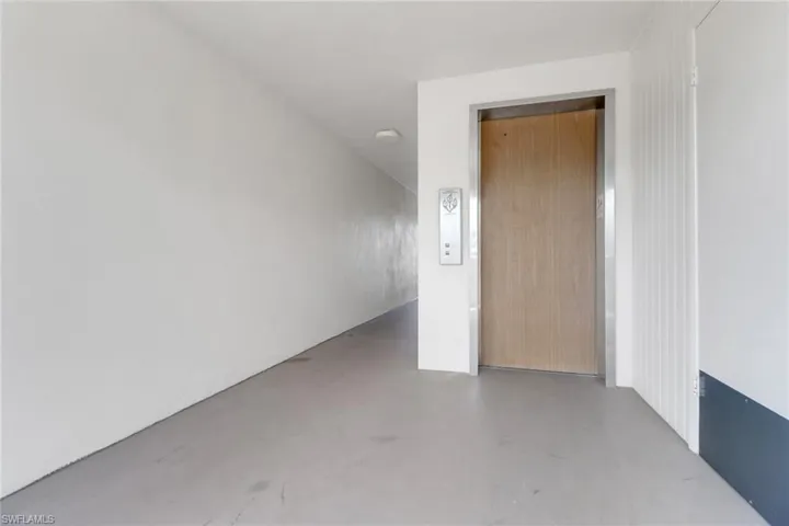 Spare room with finished concrete flooring and elevator