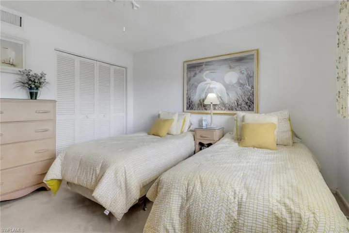 Bedroom with a closet, carpet, and ceiling fan