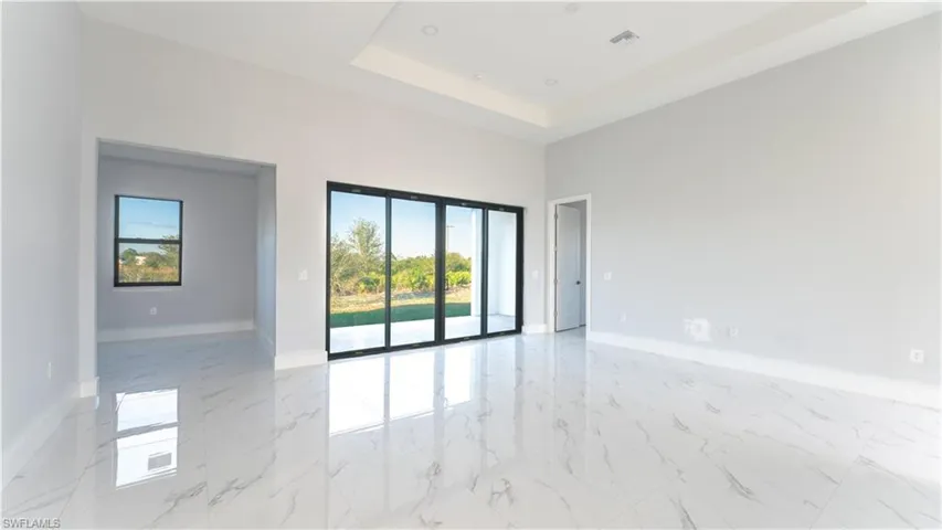 Unfurnished room with a raised ceiling