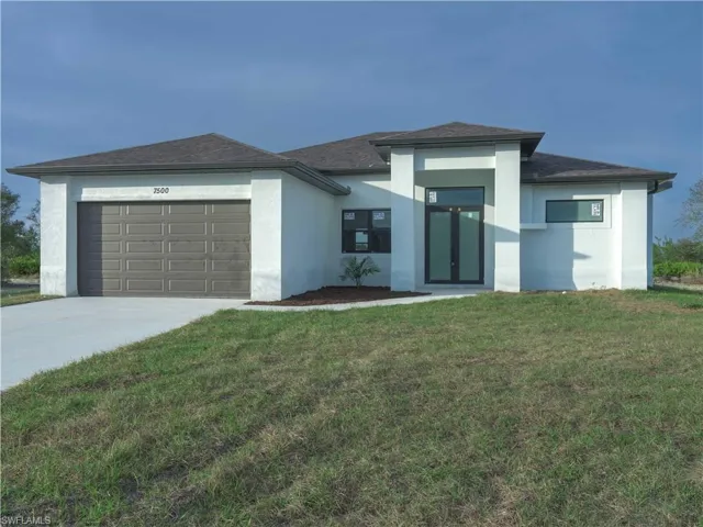 Prairie-style home featuring a garage and a front yard