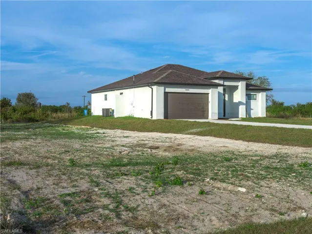 View of home's exterior featuring a garage and central AC unit
