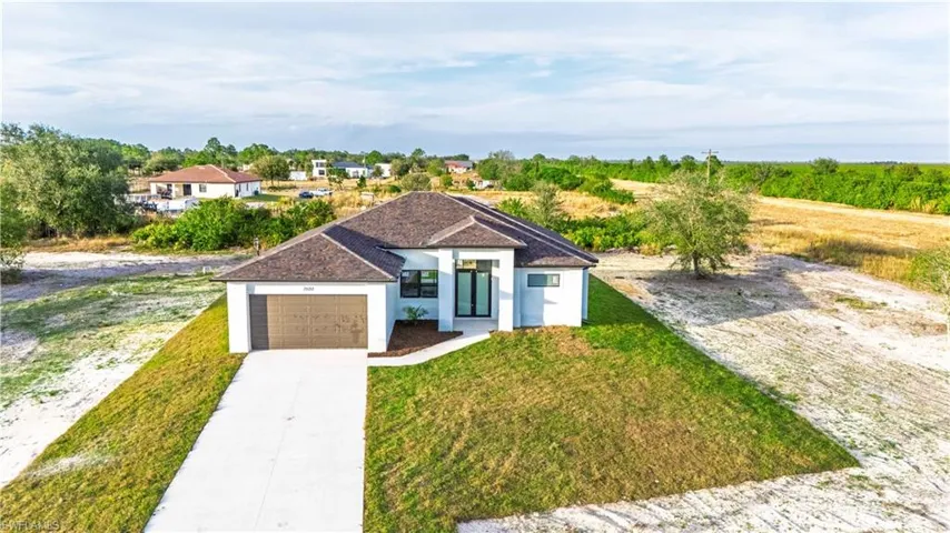 View of front of property featuring a garage and a front yard