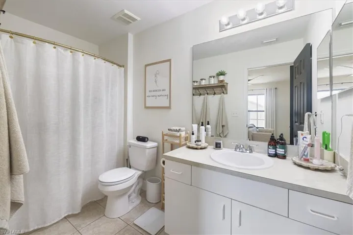 Full bath with tile patterned flooring, vanity, and connected bathroom