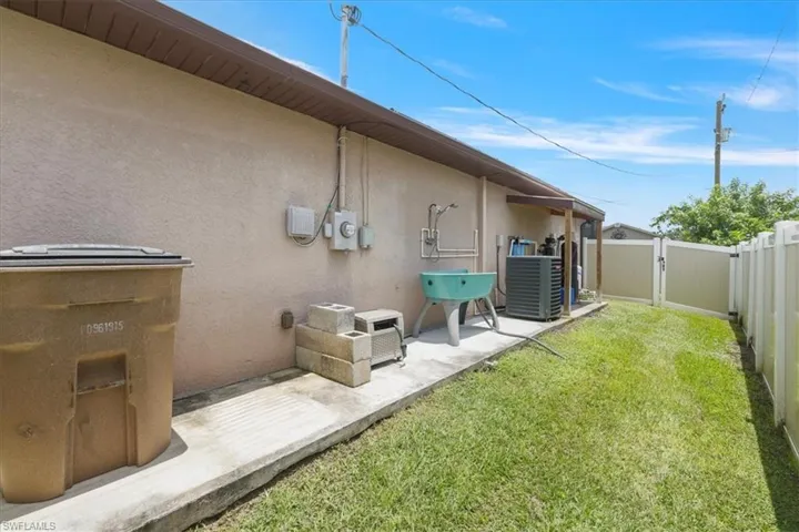 Fenced backyard featuring a gate