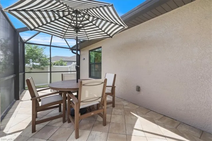View of patio / terrace featuring a lanai and outdoor dining area