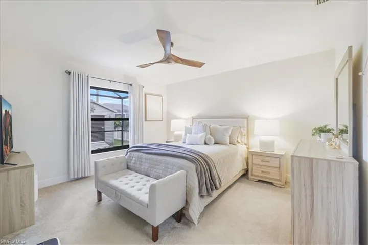 Bedroom featuring light colored carpet and ceiling fan