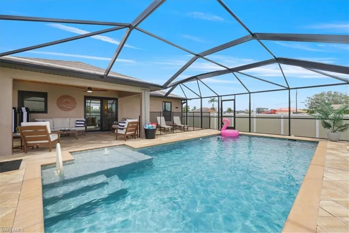 Swimming pool featuring a patio area and an outdoor living space